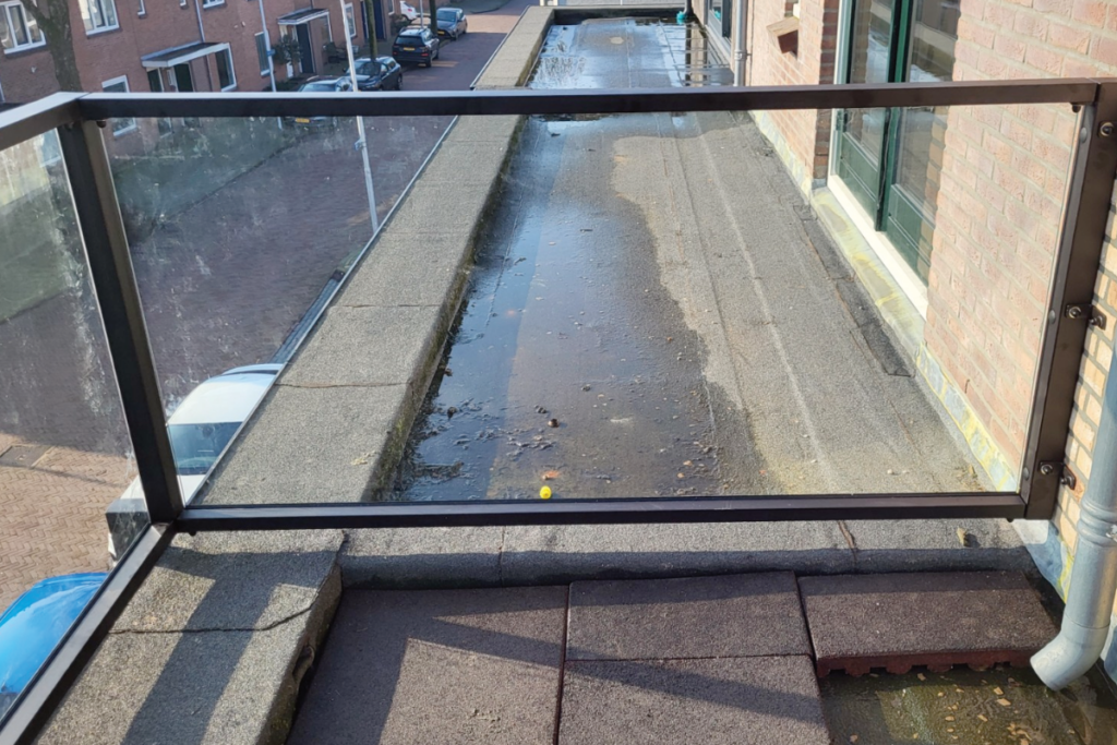 Glazen balustrade om dakterras in IJmuiden